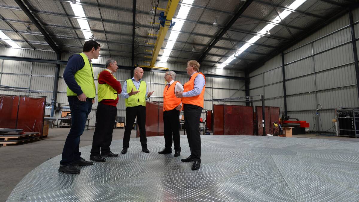 Peter Ryan with representatives from the Australian Turntable Company on one of their industrial scale turntables. Picture: JIM ALDERSEY