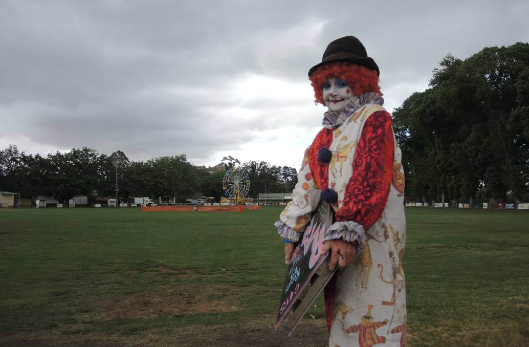 SHOW STOPPER: "Blossom" the face painting clown helps to pack up after the Castlemaine Show finished on Saturday. Picture: ADAM HOLMES