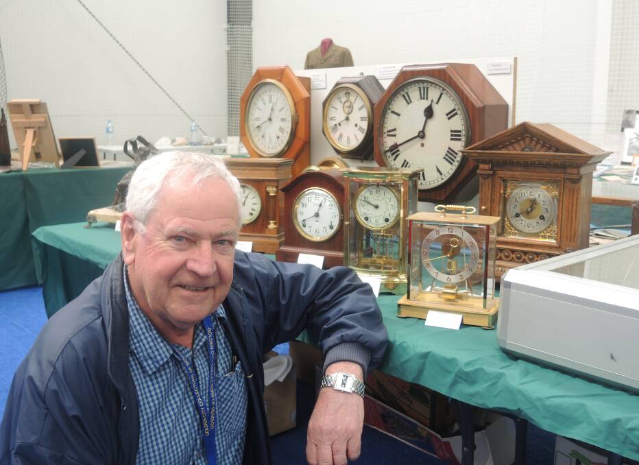 GOOD TIMES: Les Lewis with his antique clocks at the weekend collectibles show.