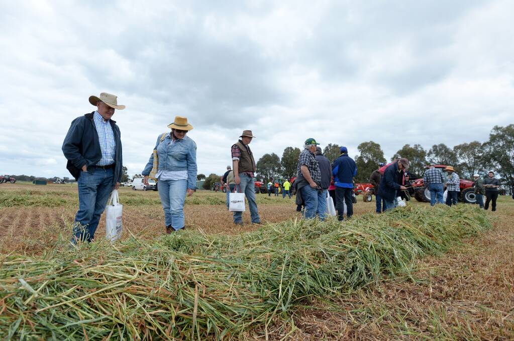 UP CLOSE: Farmers inspect the handiwork of farm machinery in the demonstration paddock. Picture: JIM ALDERSEY