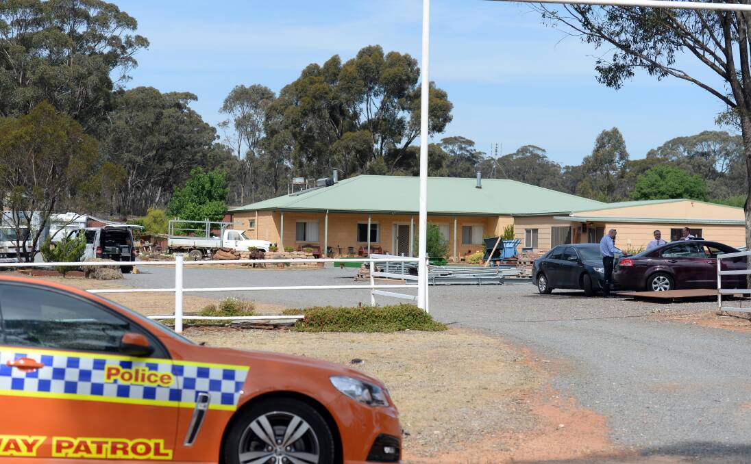 INVESTIGATION: Detectives investigate a property on Wedderburn-Logan Road involved in Wednesday night's triple homicide. Picture: BILL CONROY