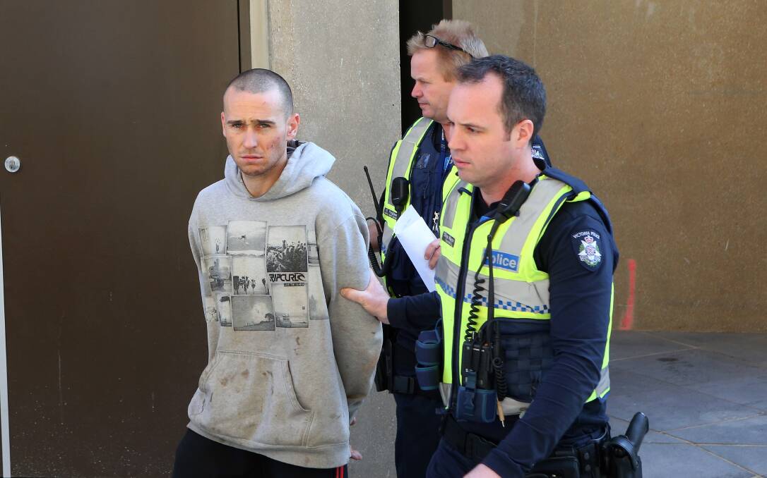 Matthew Drew is led out of the Bendigo Magistrates' Court on Wednesday.