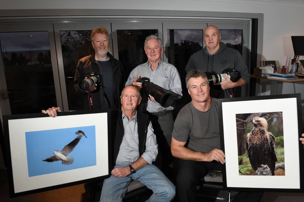 TEAMWORK: Chris Cope, John Clow, Pug Ryan (back), Daryl Fleay and David Gemmell (front) will host an exhibition of their photographs of the birds of prey of central Victoria. Picture: JODIE WIEGARD