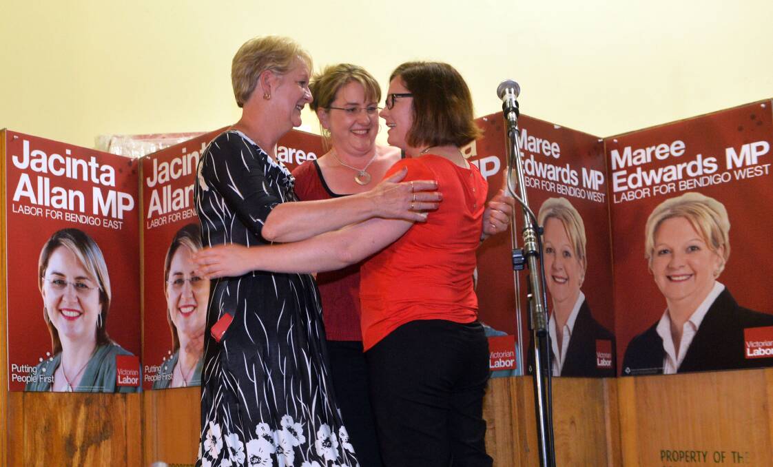 EMBRACE: Maree Edwards, Jacinta Allan and Lisa Chesters share a hug on stage at Bendigo Trades Hall. Picture: BRENDAN McCARTHY