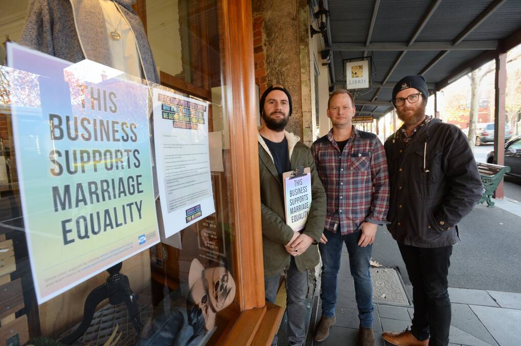 Kane Barri from The Meadow, Simon Dart from SB Libris and Tim Dalton from Brewhouse Coffee Roasters are proud to display signs supporting same sex marriage. Picture: JIM ALDERSEY