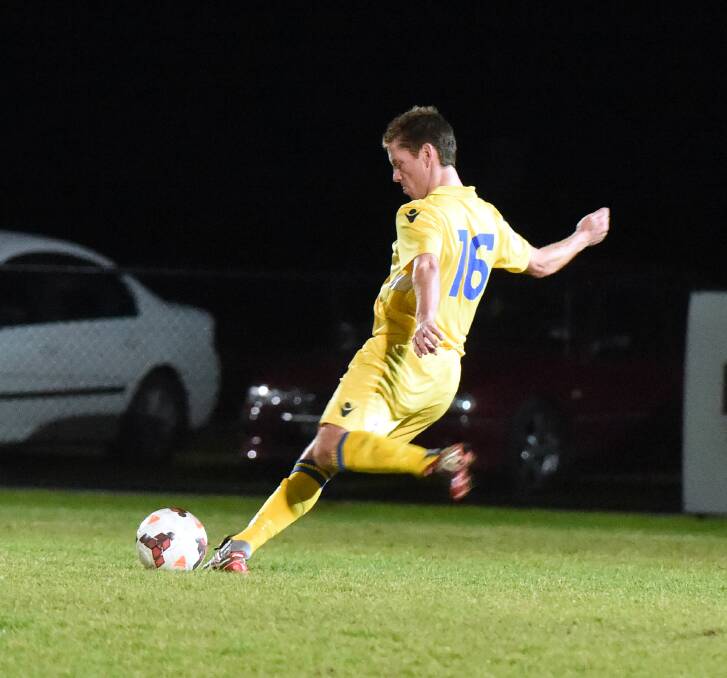 CLEARING KICK: FC Bendigo playing coach Steve Martin in last Saturday night's clash with St Albans at Epsom-Huntly Reserve. Picture: LIZ FLEMING 