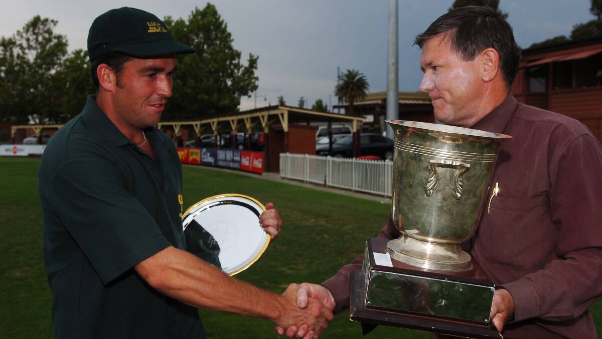 Castlemaine captain Brenton Jones is congratulated by Bendigo District Cricket Association secretary John Hecker after the division one grand final in 2006 at the QEO. 