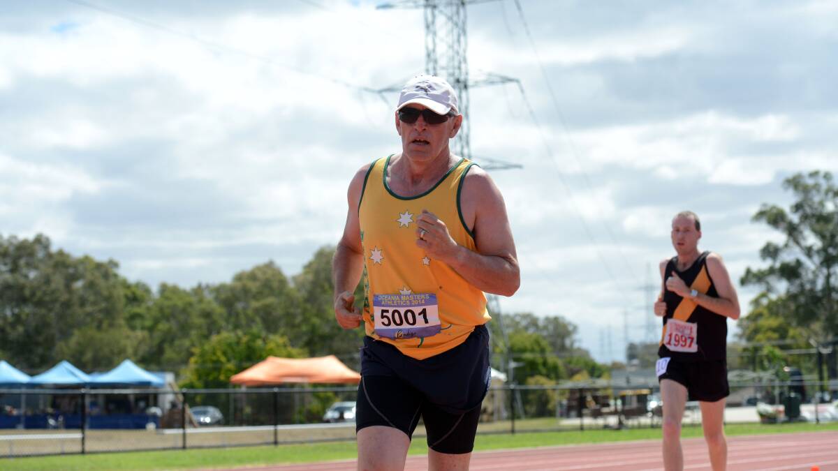 FIGHTING ON: William Barker runs in the 1500m leg of the 50-54 years decathlon at the Oceania Masters athletics championships in Bendigo. Picture: LIZ FLEMING