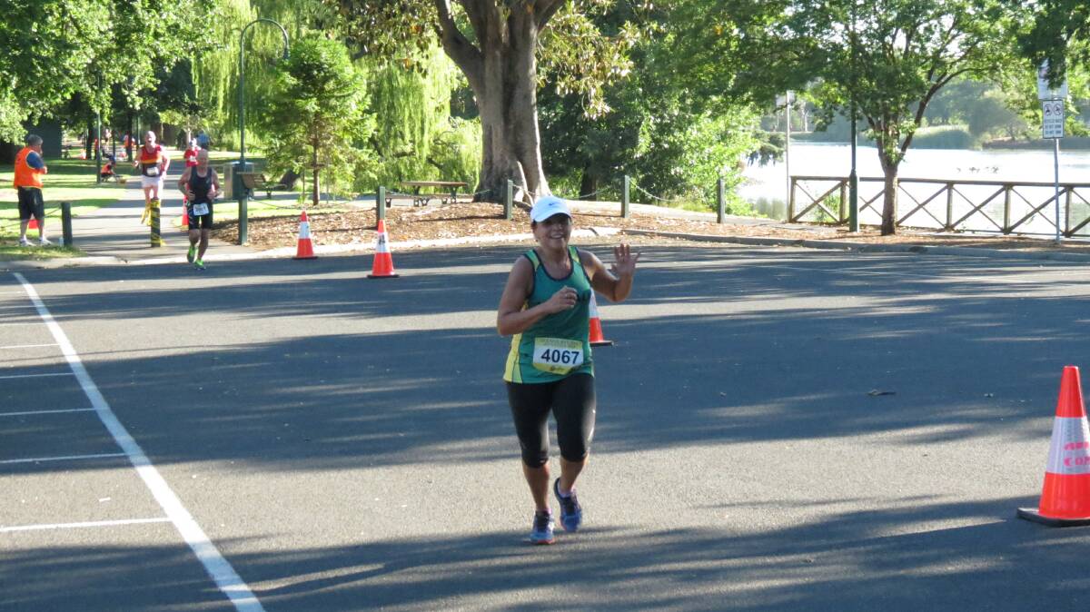 Karen Pearce was having a great time competing in the half-marathon on the final day of the Oceania Masters athletics titles in Bendigo. Picture: HUNTER GILL 