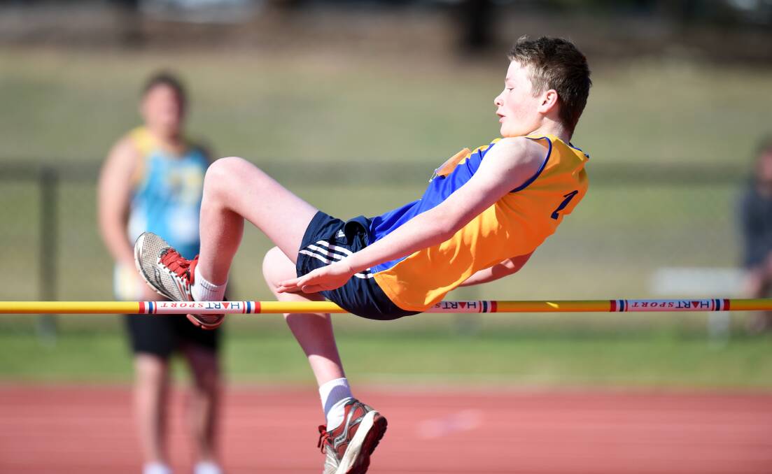 BIG LEAP: Angus McGregor competes in the under-14 triple jump. Picture: BILL CONROY