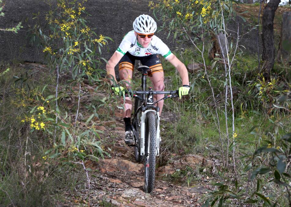 FLYING: Chris Hamilton races across the rocky terrain at One Tree Hill near Bendigo in the lead-up to another world mountain bike championships campaign. Picture: GLENN DANIELS