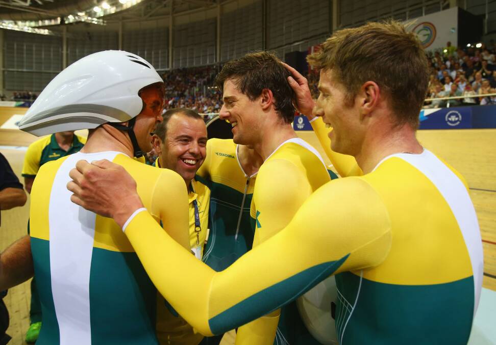 RAPT: Tim Decker is mobbed by Australia's gold medal-winning teams pursuit after their victory in Glasgow. Picture: GETTY 
