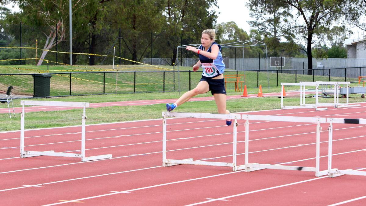 UP AND OVER: Carlie Whitford races to victory in her hurdles heat at Athletics Bendigo's meet in Flora Hill. Picture: LIZ FLEMING