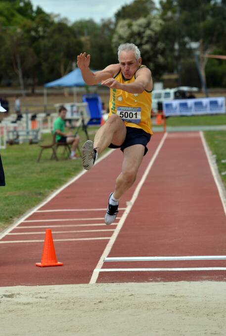 JUMP: William Barker strives for a long distance in the 50-54 years decathlon. Picture: BRENDAN McCARTHY