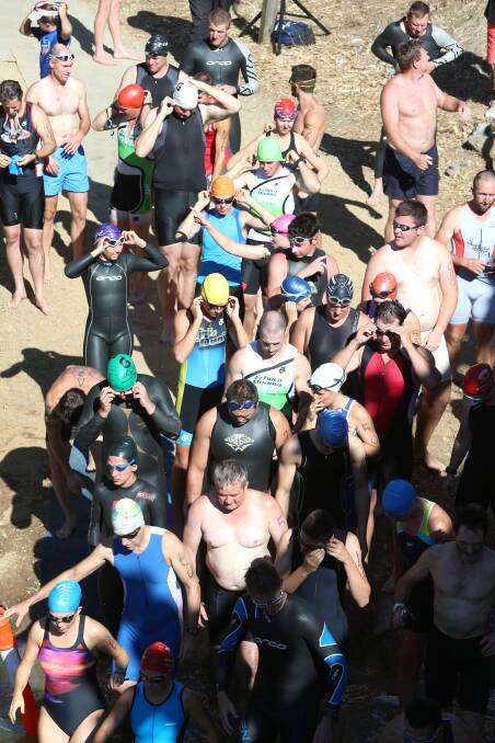 FORM A QUEUE: Competitors make their way down the bank for the start of the swim leg in the Loddon River at Bridgewater Football Netball Club's triathlon-duathlon. 