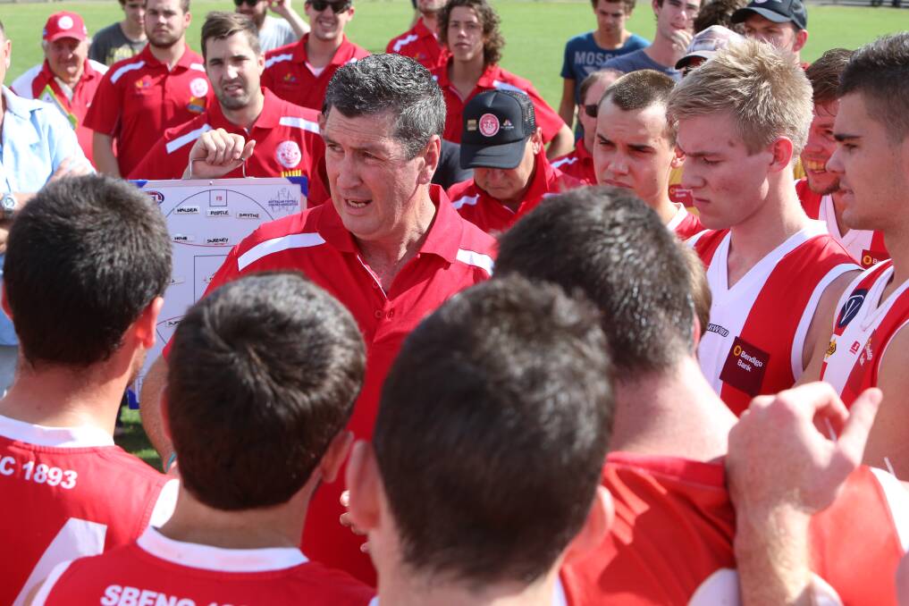 South Bendigo coach Jeff Brennan urges the players on at the quarter-time huddle. 