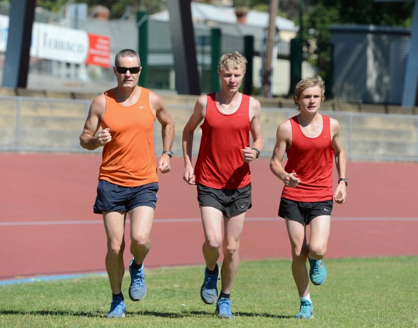 RUNNING ON: Peter, Jess and Tom Noden warm up at Bendigo's Tom Flood Sports Centre before another workout ahead of racing at the Maryborough Highland Gathering on New Year's Day. Picture: JIM ALDERSEY