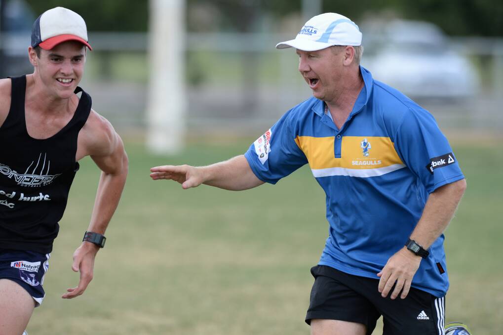 INTENSE: Andy Collins works with the Bendigo Pioneers in a training drill. Picture: JIM ALDERSEY