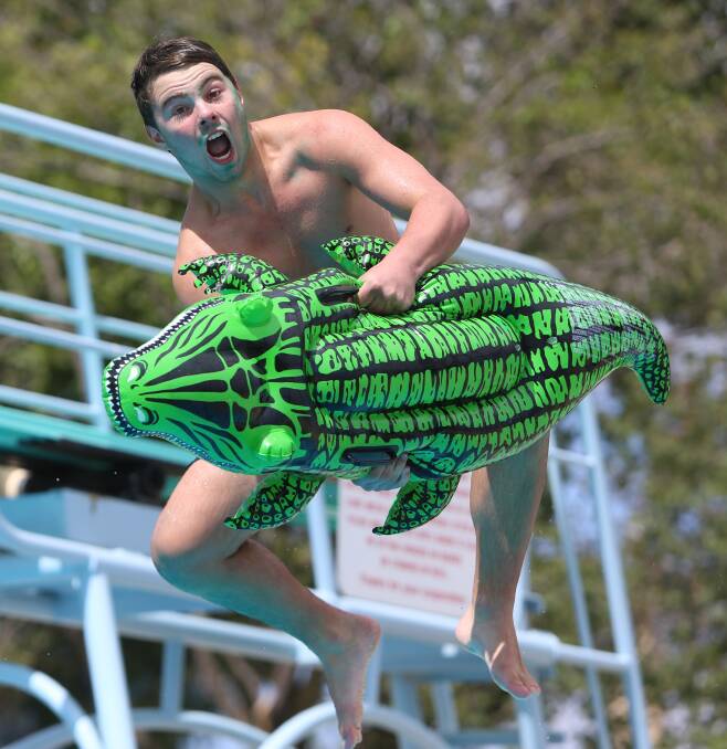 Brodie Moss, 15, shows his skill off the diving board at Eaglehawk Secondary College's swimming carnvial. Picture: GLENN DANIELS