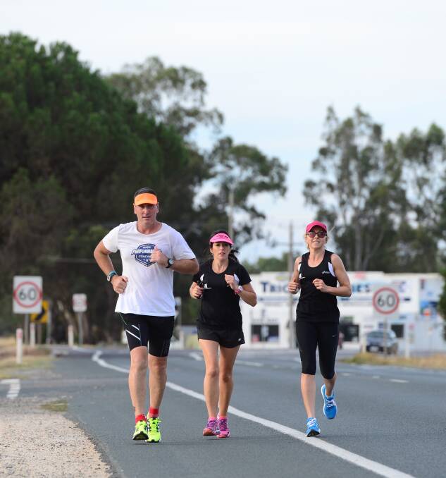 PUSHING ON: Jeff Brennan runs through Huntly with Michelle Bourke and Helen Kavanagh. Picture: JIM ALDERSEY