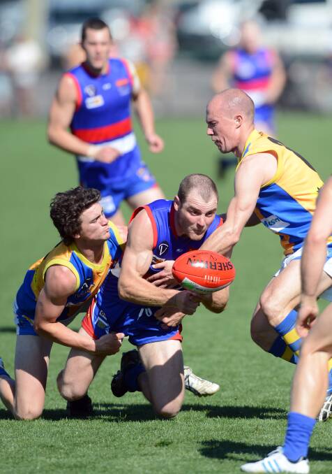 WORKHORSE: This photo from the 2012 grand final against Golden Square is typical of Ollie Messaoudi - in the contest feeding the ball out to his team-mates.