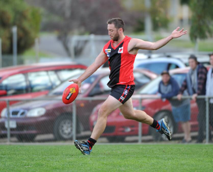Brad Wright clears from defence in the White Hills win at North Bendigo. Picture: JODIE DONNELLAN