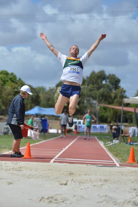 LEAP: Geoff Gibbons contests the long jump in the 35-39 years decathlon in Saturday's start to the Oceania Masters track and field championships in Bendigo. Picture: BRENDAN McCARTHY