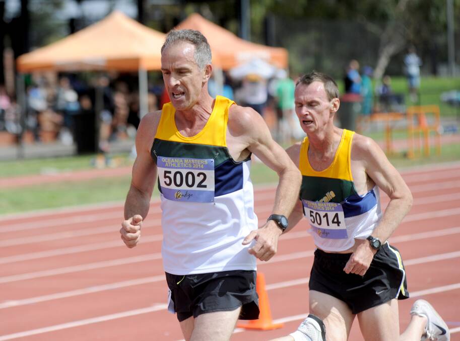 IN SYNC: Bendigo's Michael Bieleny leads Bruce Graham in the 5km race around the Flora Hill track. 