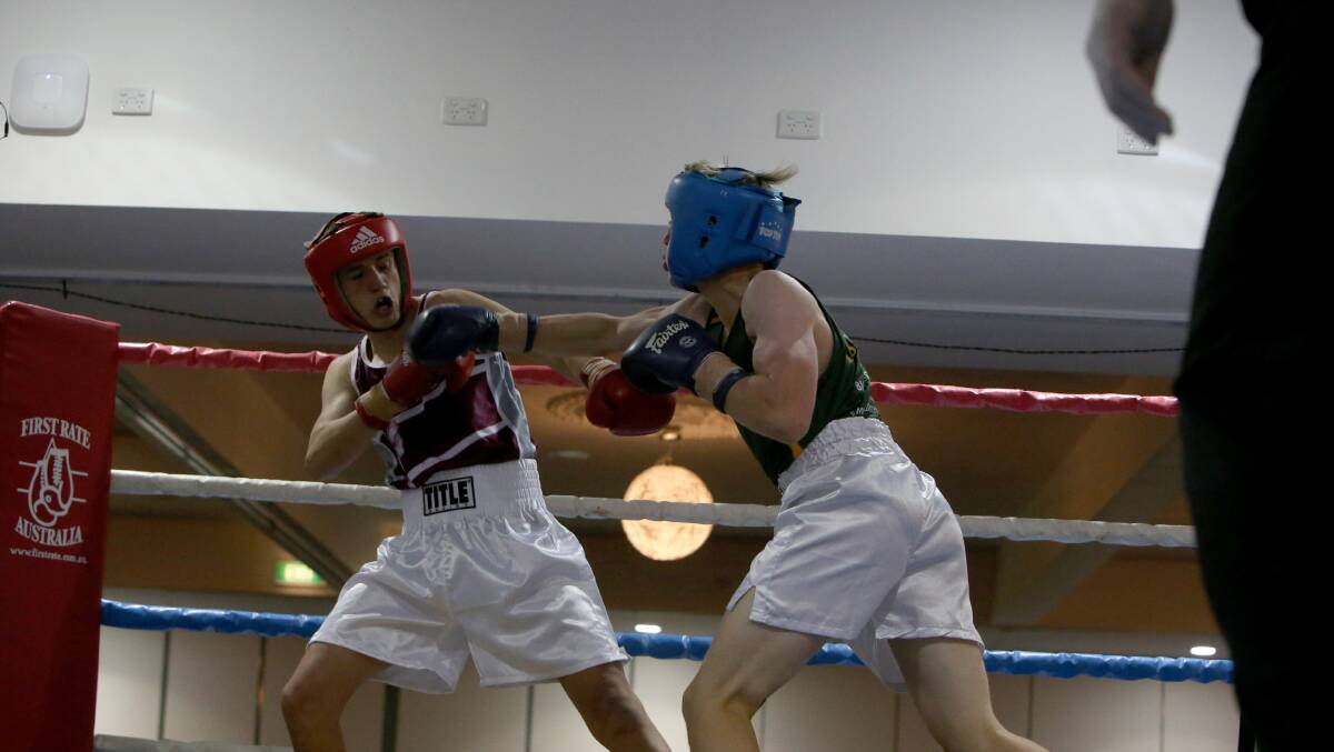 FIERCE CONTEST: Queensland's Jayden Morgan takes on Tasmania's Nick Jordan in the junior 57kg final at the Australian Amateur Boxing League national titles in Bendigo. Picture: LIZ FLEMING 