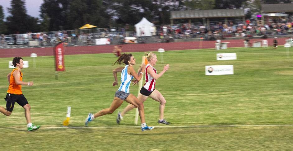 Bendigo's Kaitlyn Bryce, racing in the blue and white stripes, charges onto the home straight in the Sportzbiz novice 400m final. Picture: Picture: dionjelbartphotography