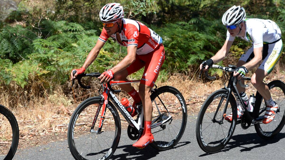 GO DRAPAC: Lachlan Norris, in red, on the climb at Mount Alexander. Picture: JIM ALDERSEY