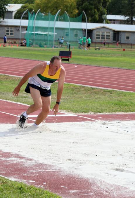 John Neale competes in the 60-64 years triple jump. Picture: LIZ FLEMING