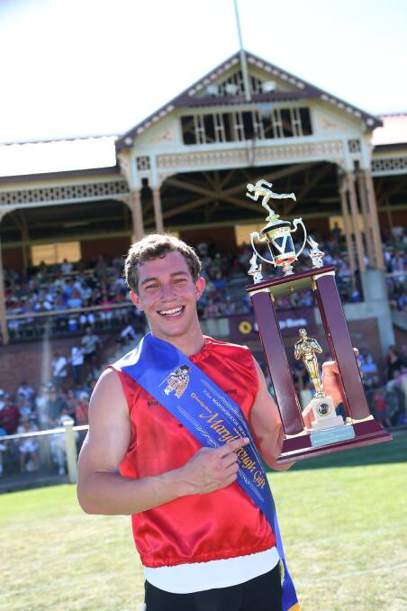 ECSTATIC: Joel Bee holds the trophy after winning the $15,000 Bendigo Bank-backed Maryborough Gift on New Year's Day in 2013. Picture: PETER WEAVING
