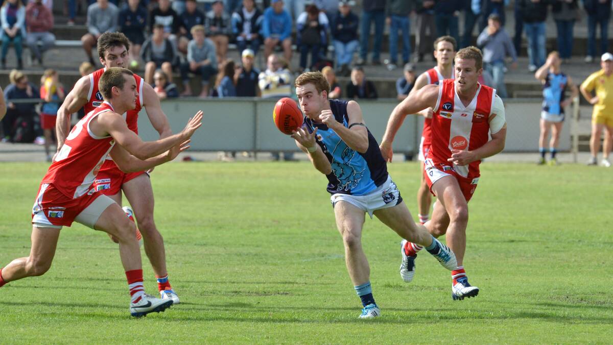 CLASS ACT: Eaglehawk's Ben McPhee handpasses in the Borough's round-three win against South Bendigo at Harry Trott Oval in Kennington. Picture: PETER WEAVING 