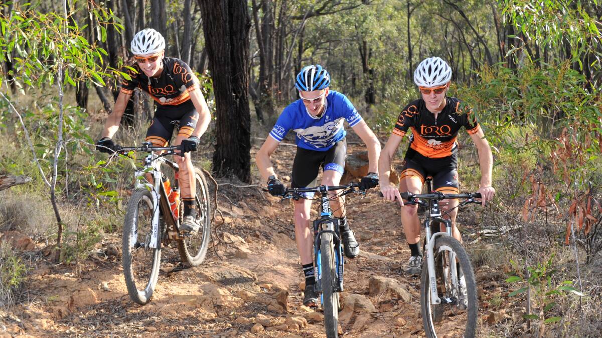 TOUGH CLIMB: Tasman and Russell Nankervis and Chris Hamilton ride one of the many tracks at One Tree Hill near Bendigo. Picture: JODIE DONNELLAN