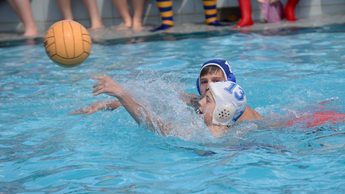 CCB's Louis Zimmer passes the ball in the water polo. 