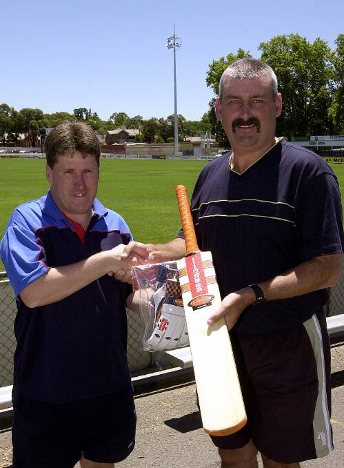 Geoff Findlay from SportsPower congratulates Benalla's Greg Hoysted on being Country Week Player of the Week in 2005. 