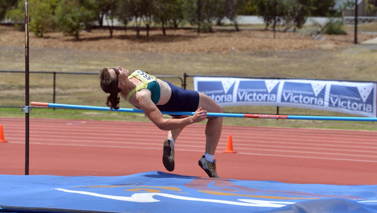 UP AND OVER: Christine Bridle clears the high jump bar in the 55-59 years heptathlon. Picture: BRENDAN McCARTHY