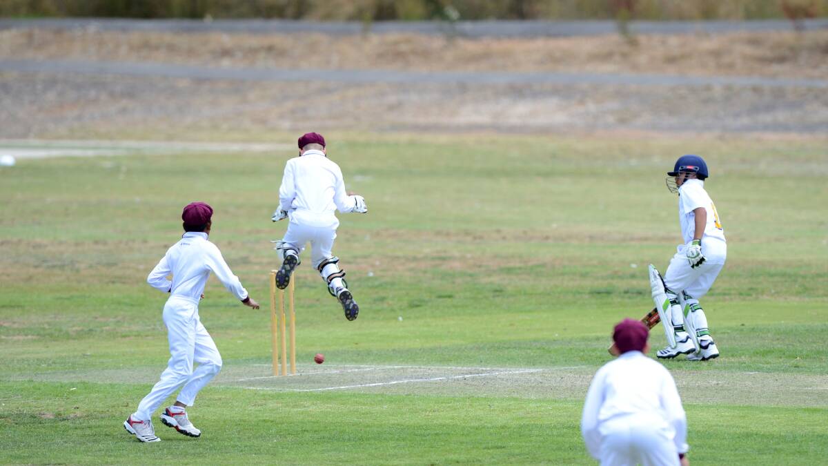 LEAP: Queensland wicket-keeper Harry Walker stops the ball in Sunday's match against ACT at Bell Oval in Strathdale. Picture: LIZ FLEMING