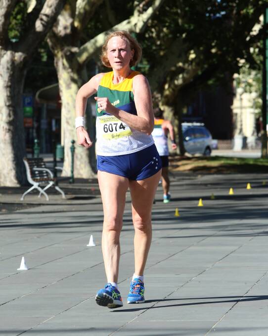 GREEN AND GOLD: Allison Thompson represents Australia in the 60-64 years class of the 10km walk at the Oceania Masters athletics championships in Bendigo. Picture: PETER WEAVING 
