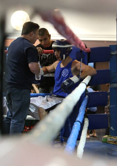 TIME-OUT: Victoria's Erin Mehmet receives instructions on his way to victory in the junior 71kg final at the Australian Amateur Boxing League national championships in Bendigo. Picture: LIZ FLEMING