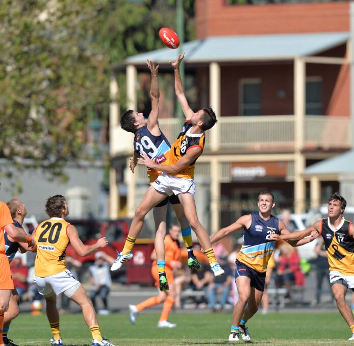 Kyneton's Brandon Spurr leaps at this centre bounce in the Bendigo Pioneers clash with Dandenong Stringrays. 