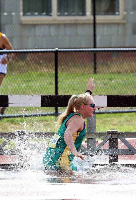 IT'S COOL: Melissa Gillick lands in the water hazard as she contests the steeplechase. Picture: LIZ FLEMING