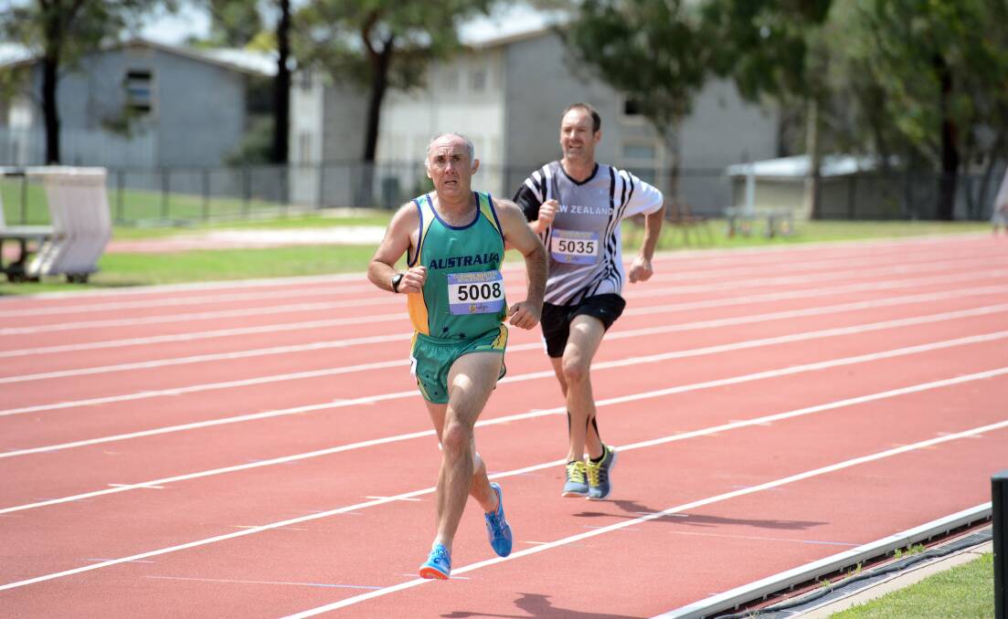 GREAT BATTLE: Tony Dell leads Bruce Solomon in the 1500m leg of the decathlon at the Oceania Masters athetics championships being run at the Flora Hill track. Picture: LIZ FLEMING
