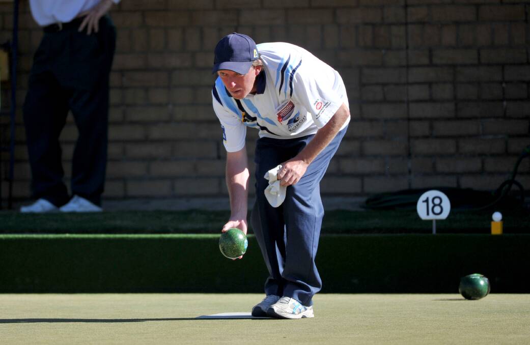 ON THE MAT: Koroit's Shane Cashill bowls in the fours action. Pictures: JODIE DONNELLAN