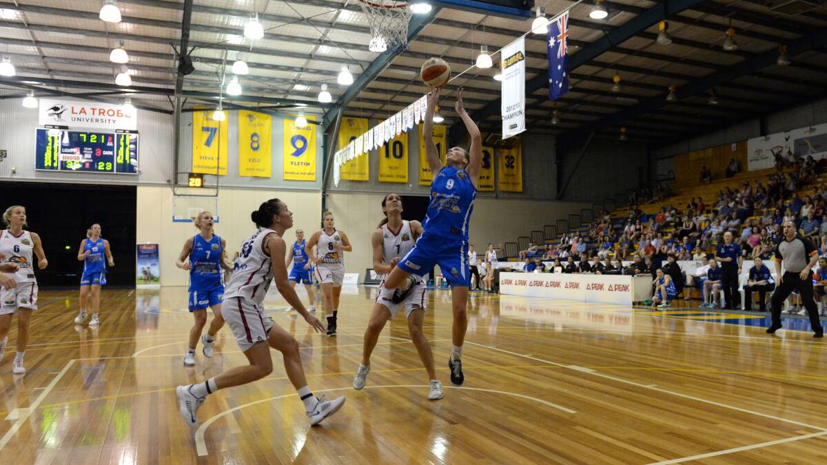 TOP SHOT: Maddie Garrick leaps to score two more points in Bendigo Spirit's victory against Logan Thunder on Saturday night. Picture: JIM ALDERSEY