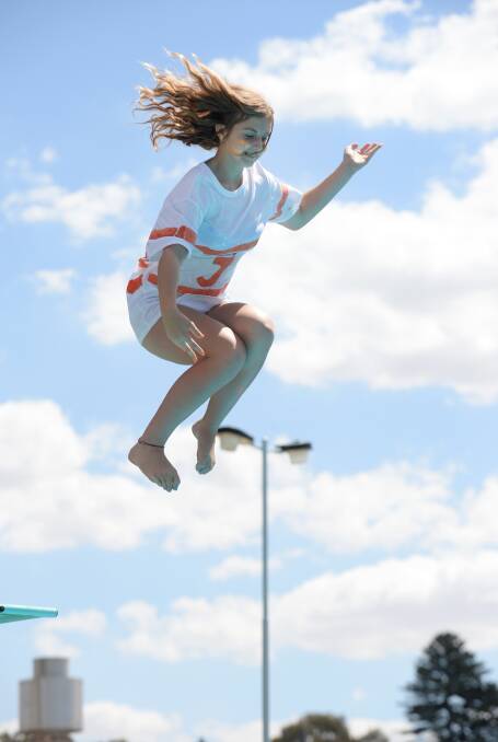 Maddie Ledwidge jumps off the 10-metre diving board.
