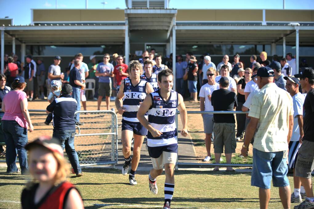 FIRST MATCH: Jono Gawthrop and Michael Pilcher lead Storm out for the club's first game in the BFL against Castlemaine in April, 2009. 