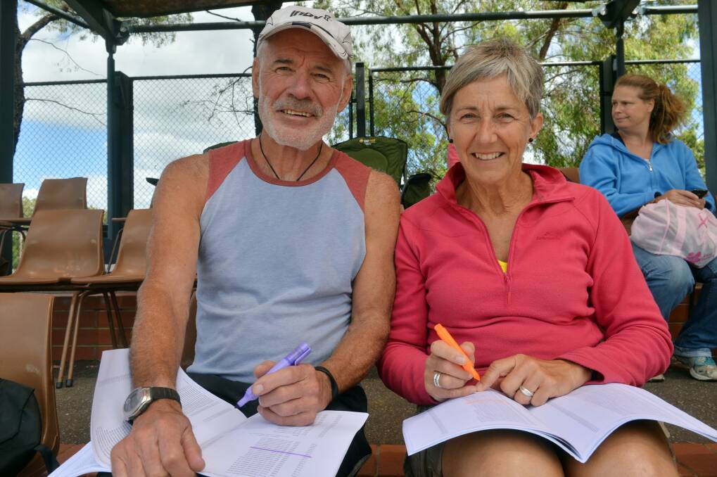 WHAT'S ON NEXT: Garry Maher from Canberra and Noelene Burden from Dunedin fill in their program during the first day of the Oceania Masters athletics championships in Bendigo. Picture: BRENDAN McCARTHY 