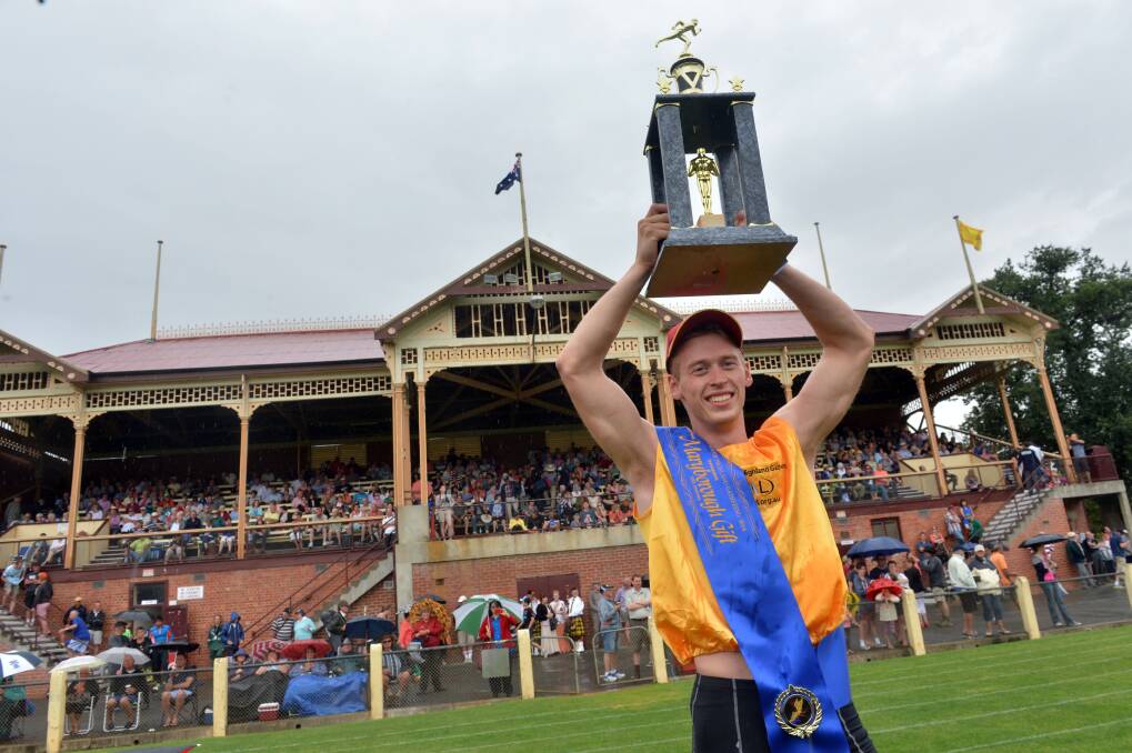 VICTORIOUS: Lee Forrest raises the trophy after winning the $15,000 Bendigo Bank Maryborough Gift on New Year's Day at Princes Park. Picture: BRENDAN McCARTHY